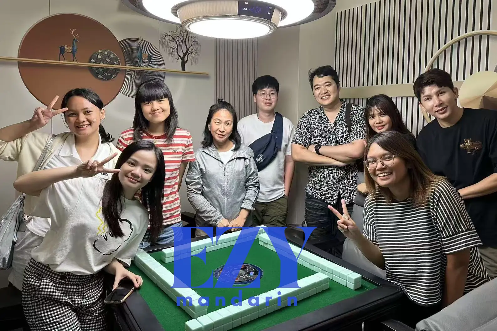 Ezy Mandarin students gathered around a mahjong table during a summer cultural activity