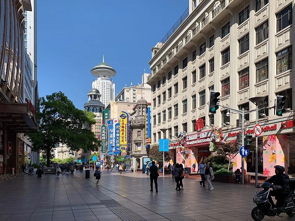 Shop signs, historic facades, and pedestrians on East Nanjing Road in Shanghai